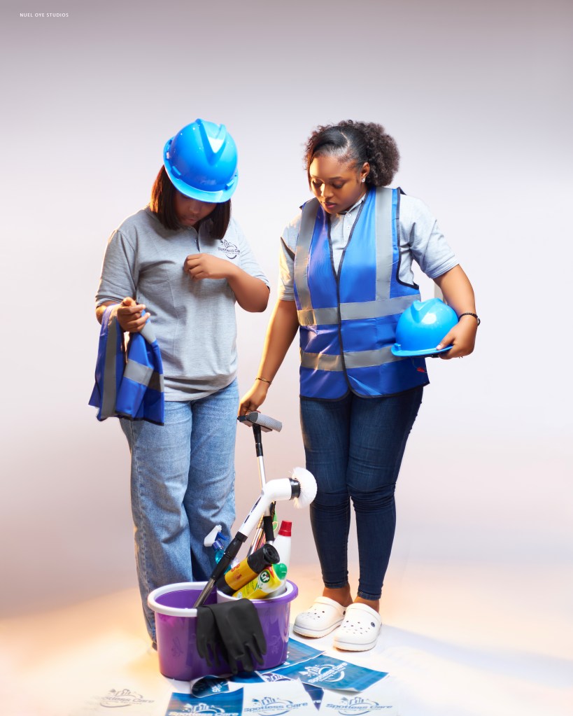 Spotless Care cleaner in branded uniform and safety gear