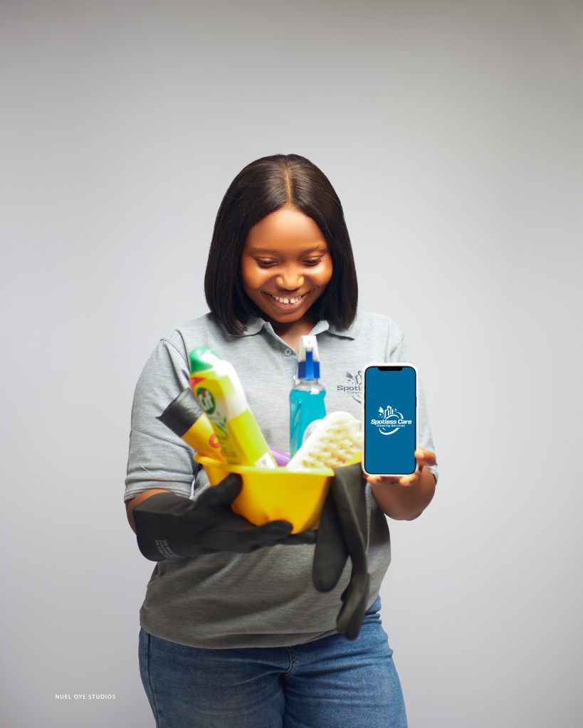 Spotless Care Cleaning Services team member in branded uniform and safety gear