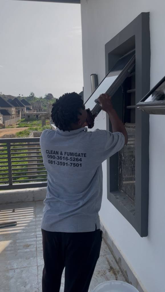 Uniformed Spotless Care cleaner working on site in Abuja